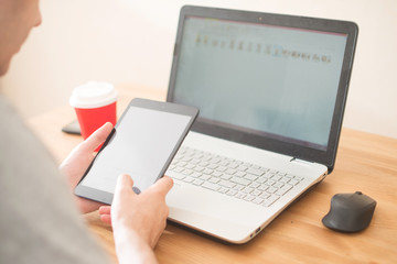 Workplace. Hands holding tablet and notebook closeup