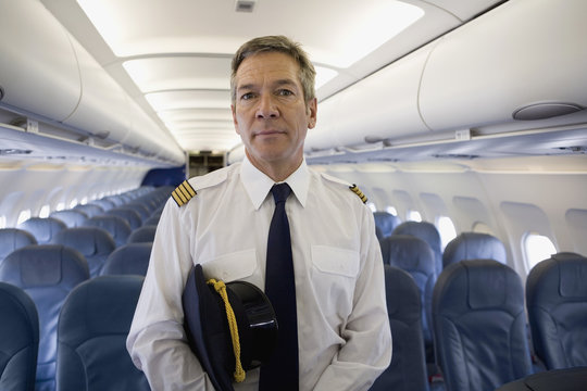 A pilot standing in the cabin of a plane