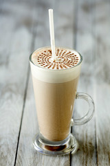 Chocolate drink in a glass on wooden background