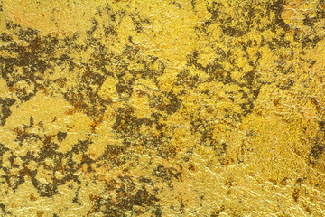 Abstract background texture of stone wall in yellow gold tone. Grunge wall. Cement wall texture and background with copy space for text or image.