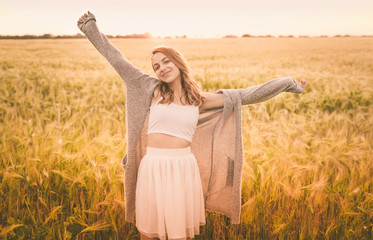 Beautiful  girl  on the field in sun light. 