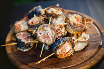 cooking rolls of mackerel on the grill, eating