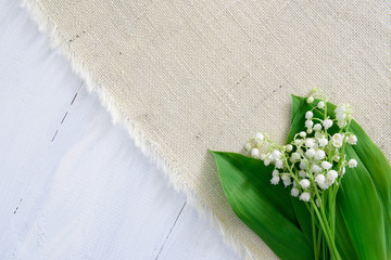 Lily of the valley on wooden background