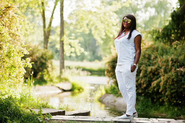 African woman at national white clothes and sunglasses