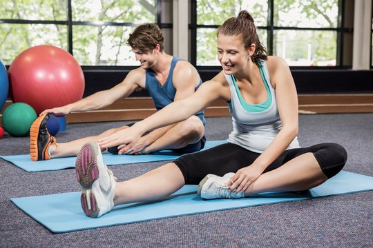Man and woman performing fitness exercise