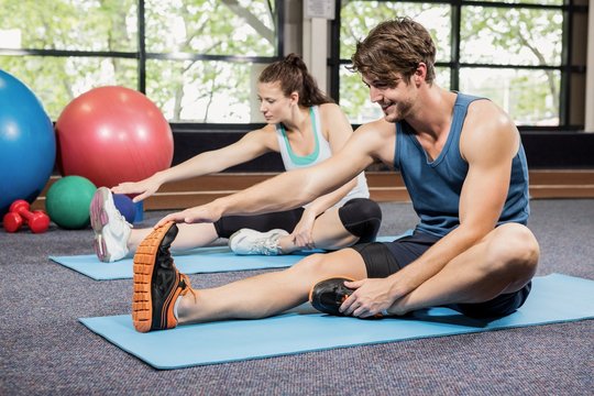 Man and woman performing fitness exercise