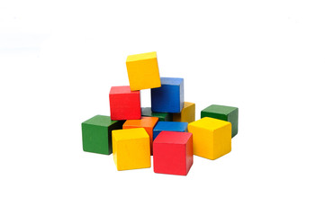 Wooden colorful building blocks isolated on white background. Cubes constructor. Vintage childrens toys.