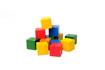 Obraz premium Wooden colorful building blocks isolated on white background. Cubes constructor. Vintage childrens toys.