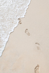 view of human steps on summer sandy beach
