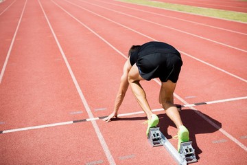 Fototapeta na wymiar Rear view of an athlete ready to run