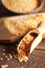 Red lentils in scoop and bowl