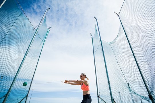 Female athlete performing a hammer throw - Powered by Adobe