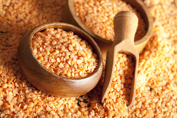 Red lentils, wooden scoop and bowl