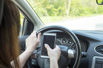 woman with a smartphone in the car