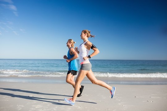 Friends Jogging At The Beach