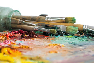 artist's palette with oil paints and brushes used for painting a