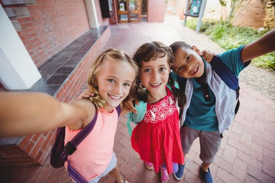 Three kids photographed like a selfie