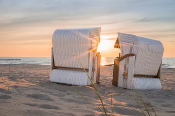 Fotobehang Geniet van de avondstemming in een strandstoel aan de Baltische Zee © ThomBal