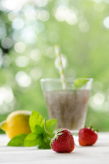 Chia seeds drink with water in transparent glass with lemon, min