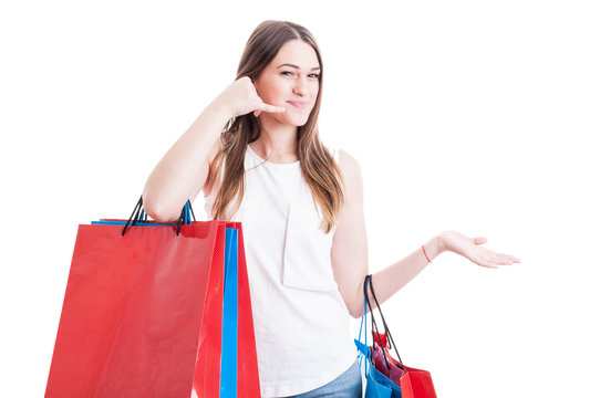 Positive girl on shopping making a call gesture with hand