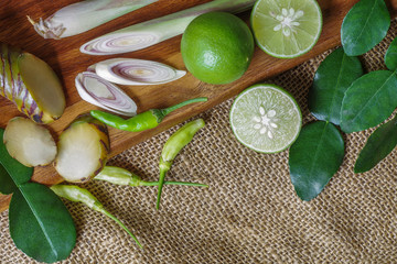 Top view of Thai food ingredients, herbs on wood and burlap back