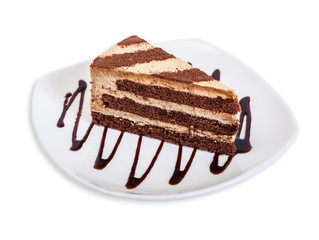 Chocolate cake Cappuccino on a white plate. Isolated on white background