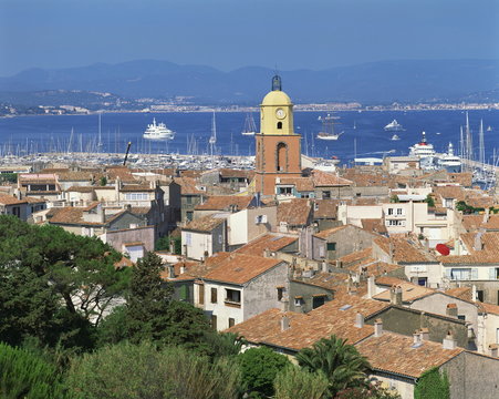 The town skyline with ships in the bay in the background, St. Tropez, France