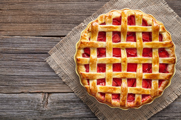 Traditional gourmet strawberry pie tart cake sweet baked pastry food on rustic wooden table background - obrazy, fototapety, plakaty