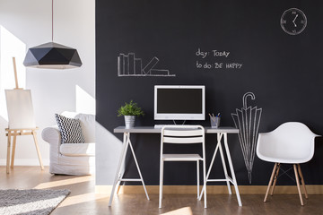 Small workspace with blackboard wall at home