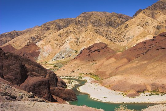 Hari Rud river flows through fertile valley at base of red rock mountains, between Jam and Chist-I-Sharif, Ghor (Ghowr province), Afghanistan