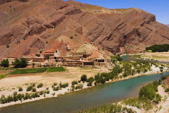 Hari Rud river flows through fertile valley at base of red rock mountains, between Jam and Chist-I-Sharif, Ghor (Ghowr) province, Afghanistan
