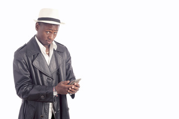 Young African American man with a cell phone isolated on white background 