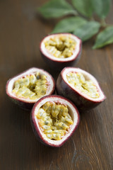 Passion fruit with green leaves on wooden desk