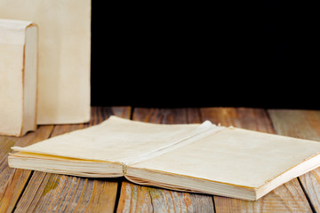 Fototapeta premium white old books on the background of wooden boards