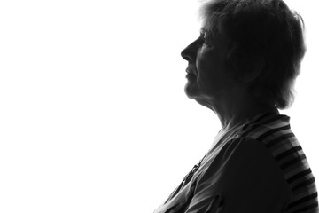 silhouette of an old sad woman