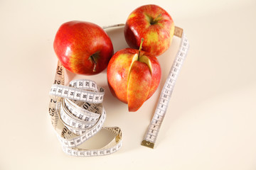 apple lying on a table with a stethoscope and measuring tape