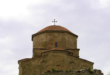 Fototapeta na wymiar View of the dome of the ancient monastery Jvari against the sky