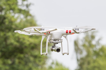 Drone equipped with camera flying in the air