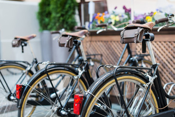 Fototapeta na wymiar Black vintage bicycles in a bike stand