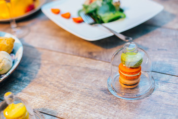 colorful macarons served on wooden dish