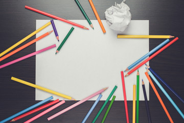 blank sheet of paper and colorful pencils creative process