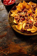 Tortilla chips, cheese and beef with copy space