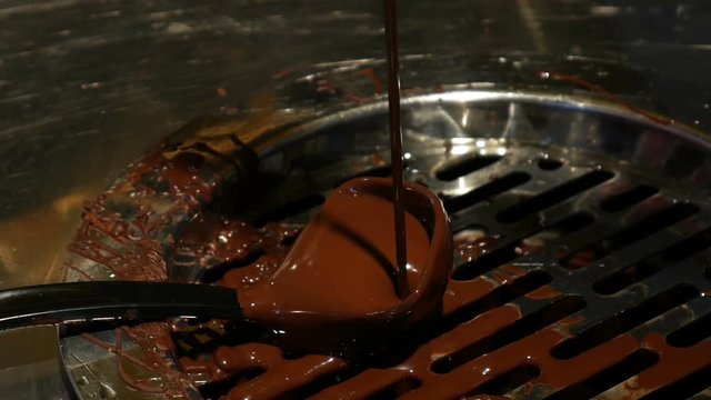 Chocolate flow. Close up of liquid hot chocolate in coffee shop, handheld shot
