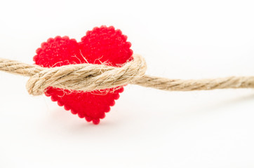 Red heart connected with a rope.