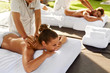 Spa Massage For Couple. Beautiful Healthy Happy People Enjoying Back Massage At Beauty Salon Outdoors. Man And Woman Relaxing On Romantic Vacation At Day Spa Resort. Health Care And Relaxation Concept