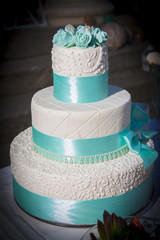 Wedding table arrangement with wedding cake, mini muffins, champagne glasses and other decorations