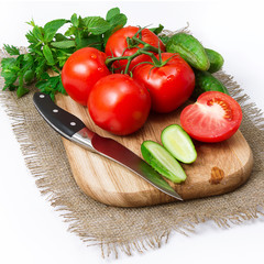 tomatoes and cucumbers on the board .