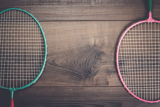 old badminton rackets on the wooden background