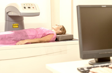 Woman undergoing mri in hospital. Healthcare concept