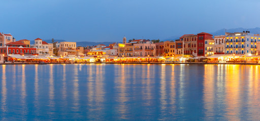 Fototapeta premium Picturesque panoramic view of old harbour and Venetian quay of Chania during twilight blue hour, Crete, Greece